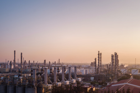 Factory of petroleum industry on sunrise sky background, Oil and gas refinery industrialのeditorial素材