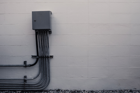 Electrical box and pipeline connection with white brick wall