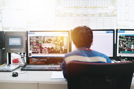 Professional technician sitting in control room monitoring process petrochemical plant, Asian broad man operate process plant, Engineers workの写真素材