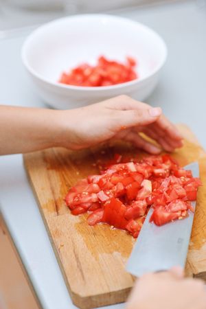 Cutting tomatoes for a saladの写真素材