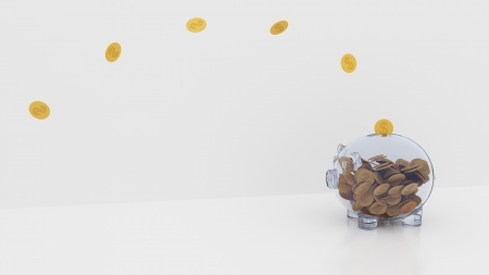 Pink piggy bank, with coins falling into one by oneの写真素材