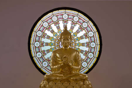 Image of buddha in front of a colorful stained glass. の写真素材