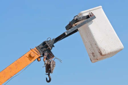 Top part of a heavy crane against a blue sky.の写真素材