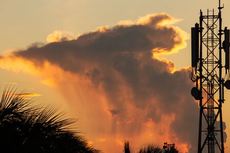Beautiful view of clouds during sunset and the cell phone tower in foreground