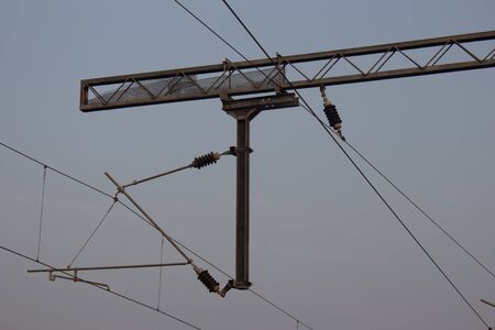 View of overhead electric lines used by train locomotives. Pole supporting the power lines used by...