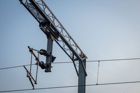 View of overhead electric lines used by train locomotives. Pole supporting the power lines used by...
