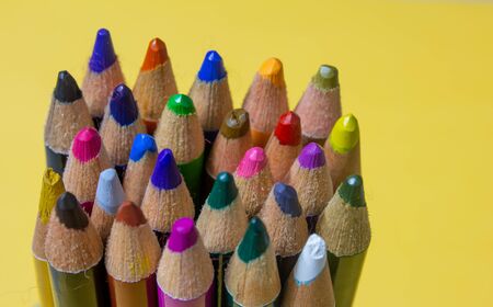 Colour pencils over yellow colour background. Student art supplies.の写真素材