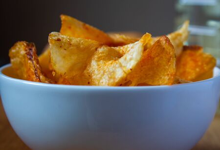 Close view of spicy potato chips in a bowlの写真素材