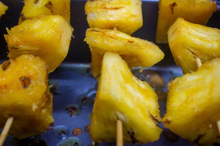 pineapple skewers with spices ready for grillingの写真素材