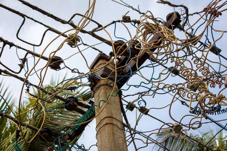 View of electric wires in a pole supplying electricity to residential homes