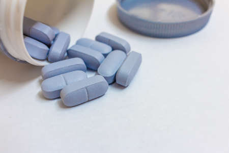 Tablets spilling out of a pill bottle. Pills out of a bottle.