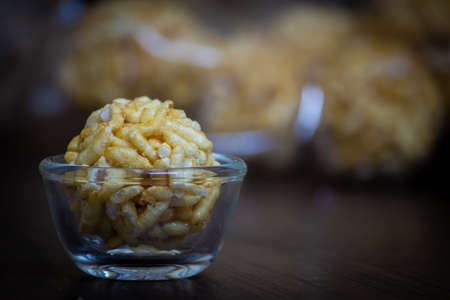 View of sweet puffed rice balls(also known as muri, porri) in a bowl. Muri ball is famous sweet of...