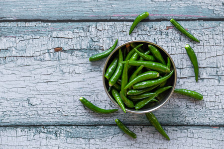 View of green chilies in a bowl. Green chilies commonly used in Asian cuisine.の写真素材