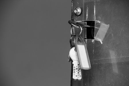 Bunch of keys hanging in a door. Door keys to open front door in home.の写真素材