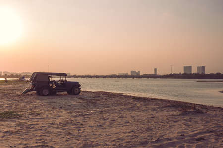 View of vehicle parked over the sands near the backwaters, east coast road, Chennai, India. Selective focusの写真素材