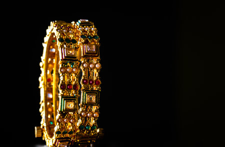 View of pair of golden bangles which is common ornament worn in India. Shiny bracelet jewelry with...