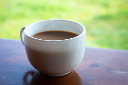 Hot refreshing cup of tea against natural background. Break with tea time.の写真素材