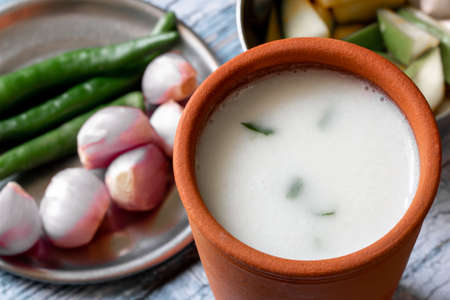 Fermented rice mixed with curd along with side dish of onion and green chili. Traditional South...