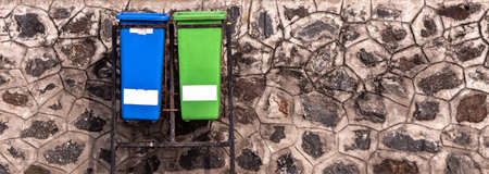 Dustbins along the public space for people to segregate and dispose waste accordingly. Separate bins for biodegradable and plastic waste.の写真素材