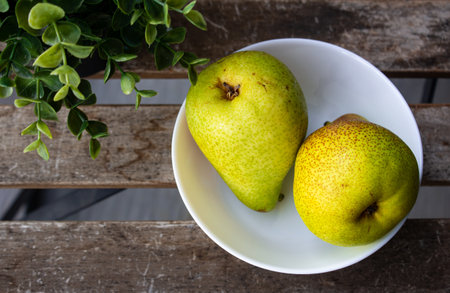 Pair of pear fruit in a bowl which is rich in essential antioxidants, plant compounds, and dietary fiber.の写真素材