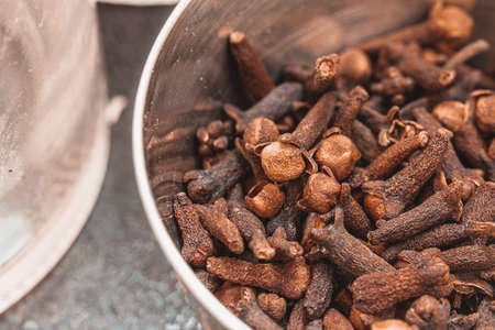 Dried cloves in a steel bowl. Spice clove for favoring.の写真素材