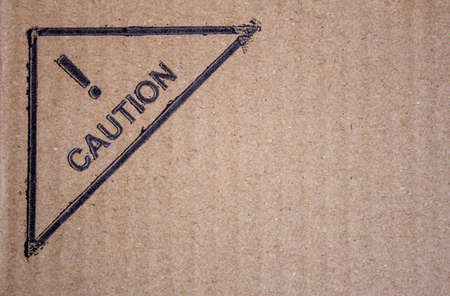 View of cardboard with caution sign. Package box with symbol cautioning fragile items and need...