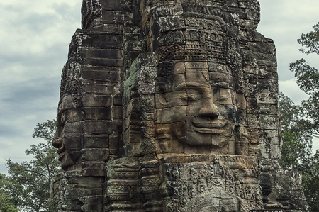 Stone head on towers of Bayon temple in Angkor Thom, Cambodiaの写真素材