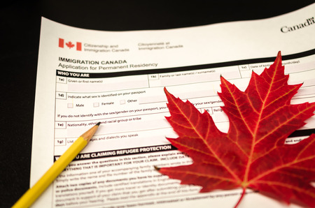 canada immigration form with pencil and maple leafの写真素材