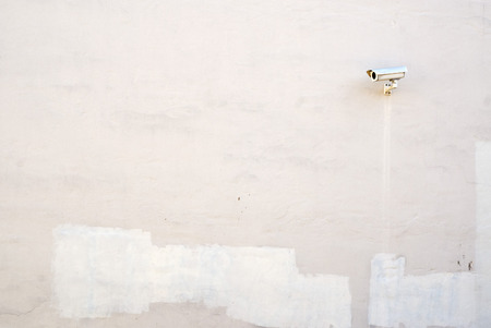 Security camera on the stucco wallの写真素材