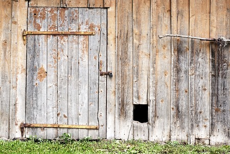wooden wall with a door and hole for the dogの写真素材