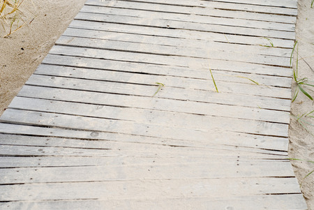 Wooden plank path on the sandy beachの写真素材