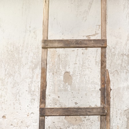 old, weathered brick wall, ladder near the wall backgroundの写真素材