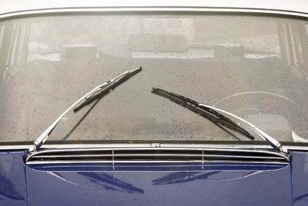window with wipers of blue vintage car