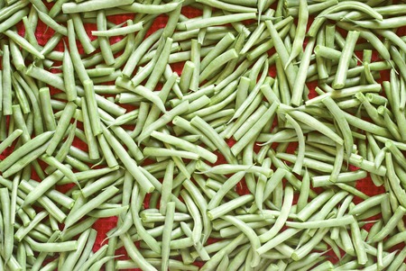 Green beans on the red towel background
