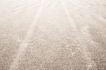 tyre tracks on the sand at the beach, winter time, snow and sand backgroundの写真素材
