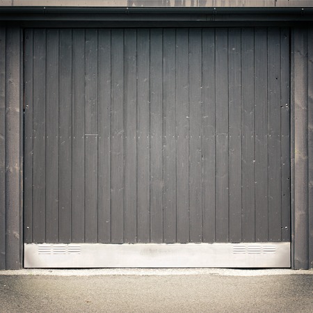 dark black wooden garage door, asphalt groundの写真素材