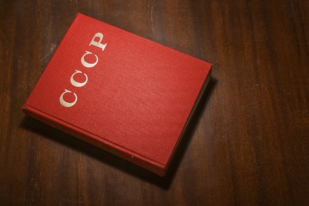 Red book on the wooden scratched table,  CCCP  written on the coverの写真素材