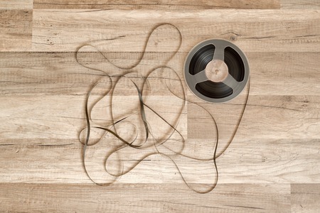Vintage magnetic audio reel on the grunge wooden floorの写真素材