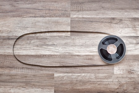 Vintage magnetic audio reel on the grunge wooden floorの写真素材