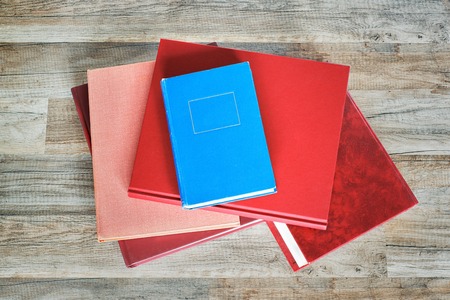 stack of red and blue books on the floorの写真素材