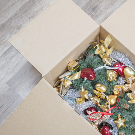 christmas tree, glitter baubles and tinsel in the paper box