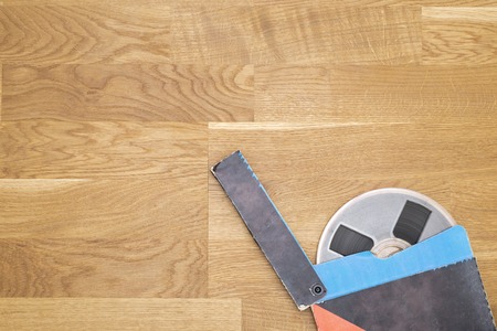 Vintage magnetic audio tape, reel to reel type, paper box on the grunge wooden floorの写真素材