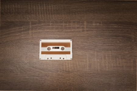 Vintage audio tape on brown wooden background