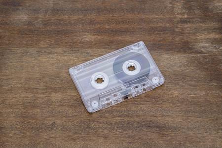 Retro audio tape on brown wooden background
