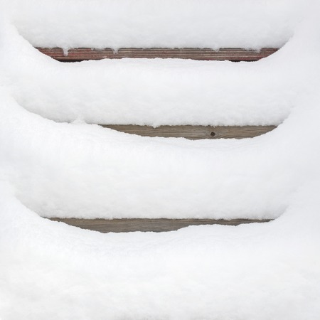 Wooden stairway covered with fresh snow, winter timeの写真素材