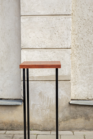 outdoor table near the grunge wall at coffee shopの写真素材