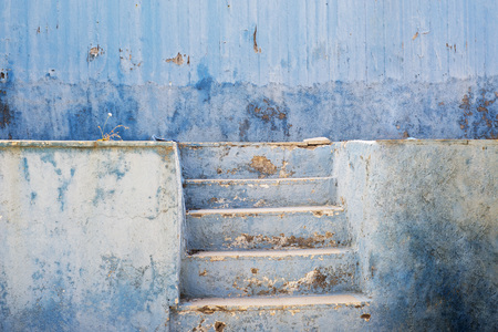 blue abandoned grunge cracked stucco wall and stairsの写真素材
