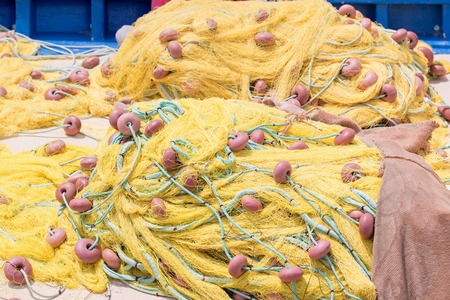 Yellow fishing net on the cement quay