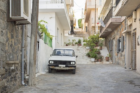 Elounda, Crete, Greece - June 16, 2017: Old rusty white car parked in the streetのeditorial素材
