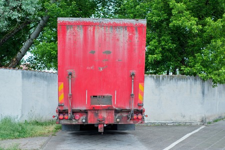 Back of redtruck with hydraulic ramp going through gates